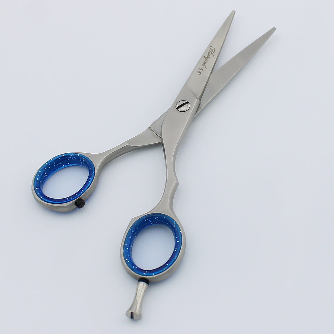 High-quality 5.5-inch chrome shears with ergonomic handle and removable finger inserts for controlled precise cuts